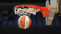 Wilson official basketball with WNBA logo goes through the net during the game between the LA Sparks and the Las Vegas Aces at Crypto.com Arena.