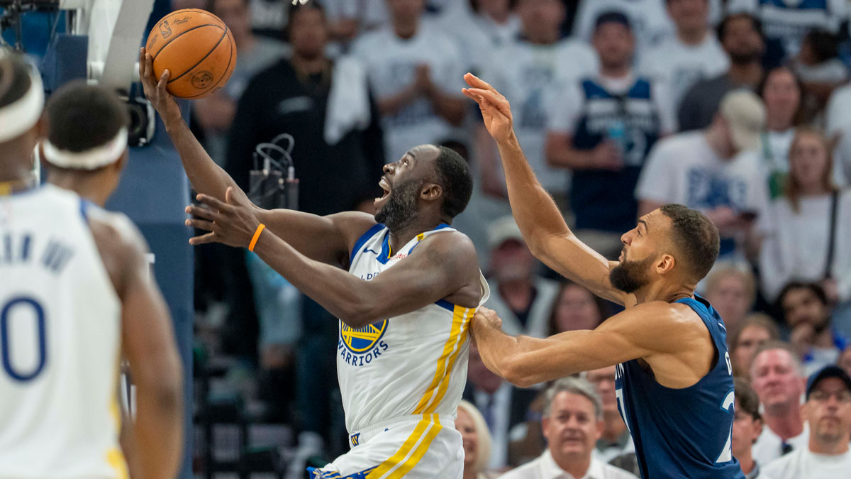 Warriors forward Draymond Green (23) drives to the basket past Minnesota Timberwolves center Rudy Gobert (27) in the first half during game five of the second round for the 2025 NBA Playoffs at Target Center