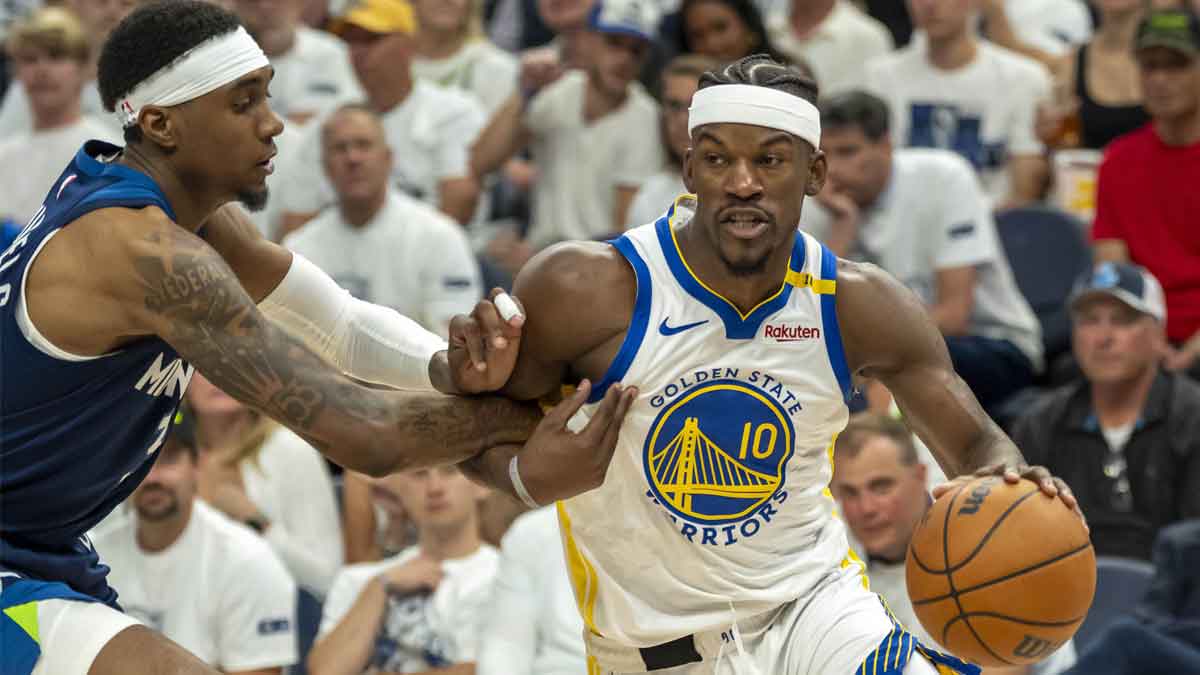Golden State Warriors forward Jimmy Butler III (10) drives to the basket past Minnesota Timberwolves forward Jaden McDaniels (3) in the second half during game five of the second round for the 2025 NBA Playoffs at Target Center.