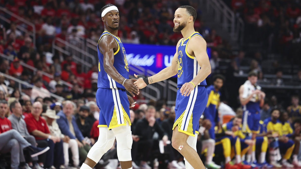 Warriors guard Stephen Curry (30) celebrates with forward Jimmy Butler III (10) after a play during the second quarter against the Houston Rockets at Toyota Center