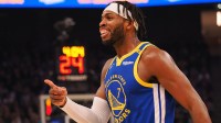 Golden State Warriors guard Buddy Hield (7) smiles after a basket as a time out is called during the first quarter against the Denver Nuggets at Chase Center.