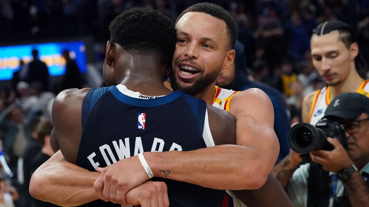 Warriors guard Stephen Curry (30) hugs Minnesota Timberwolves guard Anthony Edwards (5)