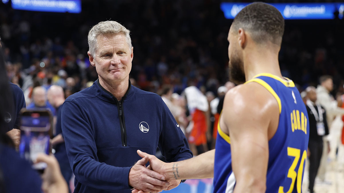 Warriors head coach Steve Kerr celebrates with guard Stephen Curry