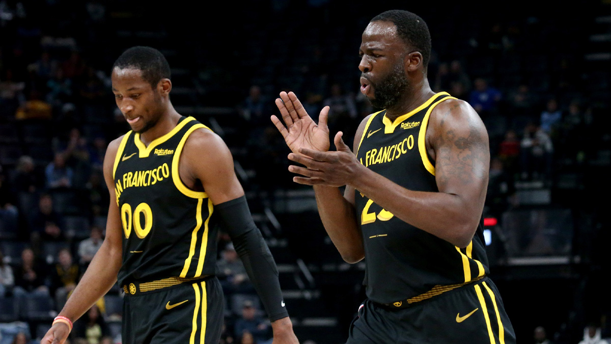 Golden State Warriors forward Jonathan Kuminga (00) and Golden State Warriors forward Draymond Green (23) walk to the bench at the end of the first quarter against the Memphis Grizzlies at FedExForum.