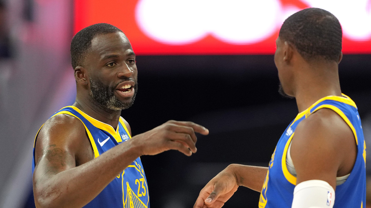 Golden State Warriors forward Draymond Green (23) talks with forward Jonathan Kuminga (right) during the third quarter against the Los Angeles Lakers at Chase Center.