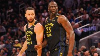 Golden State Warriors guard Stephen Curry (30) and forward Draymond Green (23) look towards an Orlando Magic player at half time at Chase Center.