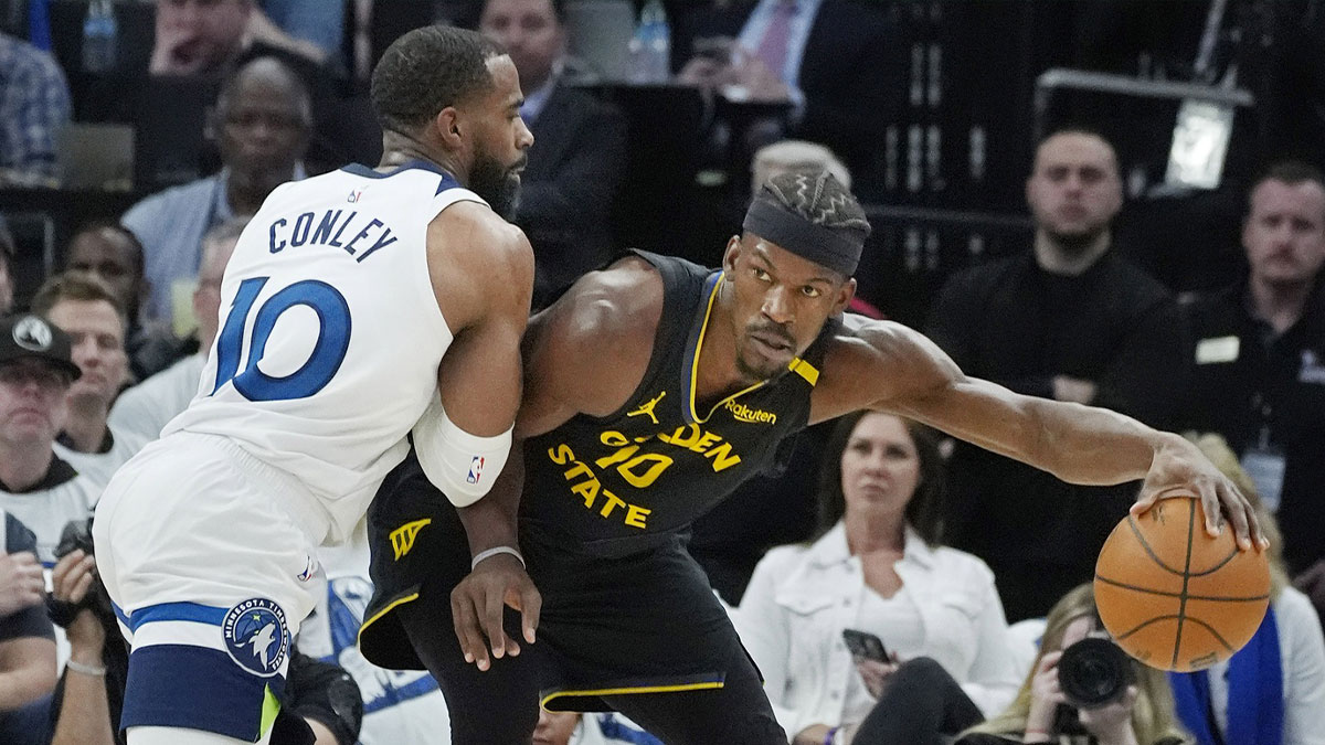 Minnesota Timberwolves guard Mike Conley (10) defends against Golden State Warriors forward Jimmy Butler (10) in the first quarter during game one of the second round for the 2025 NBA Playoffs at Target Center.