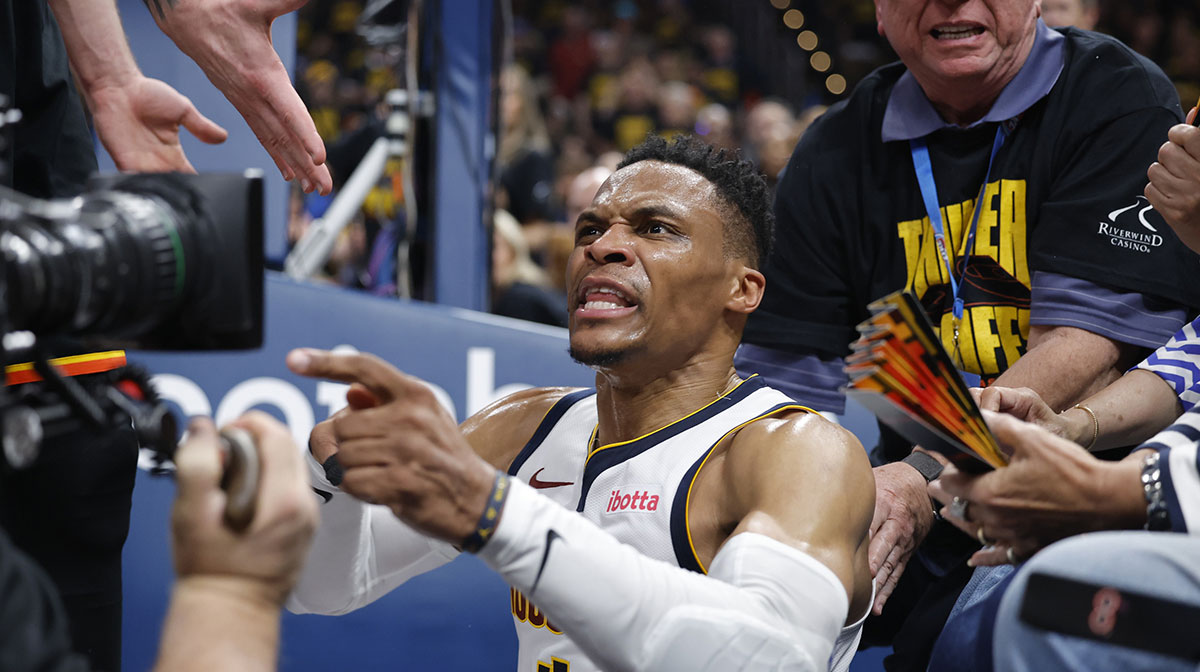 Denver Nuggets guard Russell Westbrook (4) reacts after a play and falling into fans in the second quarter against the Oklahoma City Thunder during game two of the second round for the 2025 NBA Playoffs at Paycom Center.