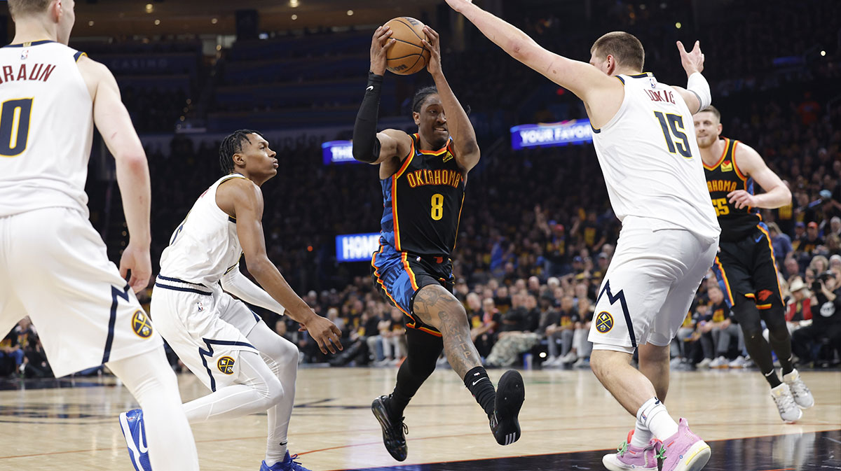 Oklahoma City Thunder forward Jalen Williams (8) drives to the basket between Denver Nuggets forward Peyton Watson (8) and center Nikola Jokic (15) during the second half in game one of the second round for the 2025 NBA Playoffs at Paycom Center.