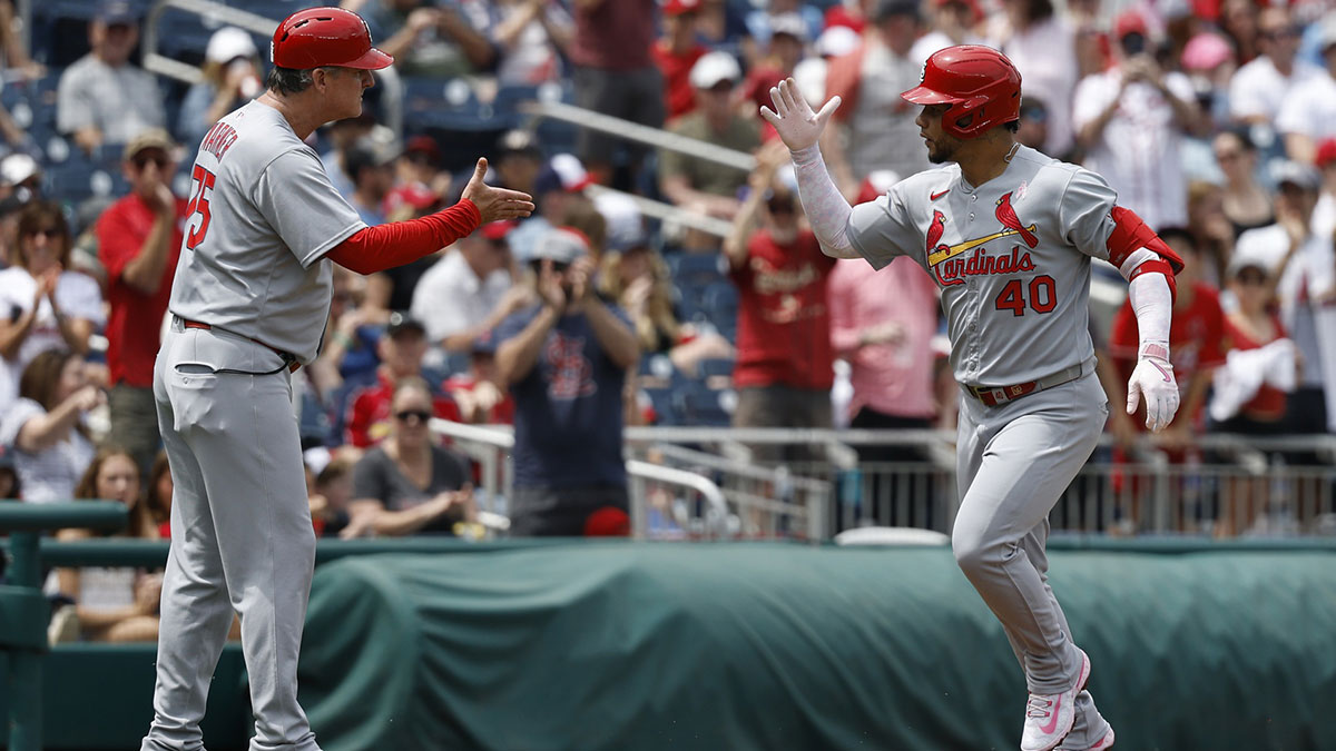St. Louis Cardinals first base Willson Contreras (40) celebrates with Cardinals third base coach Ron 'Pop' Warner (75) while rounding the bases after hitting a solo home run against the Washington Nationals during the second inning at Nationals Park.