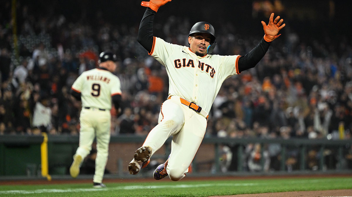 San Francisco Giants shortstop Willy Adames (2) slides home against the Colorado Rockies in the sixth inning at Oracle Park.