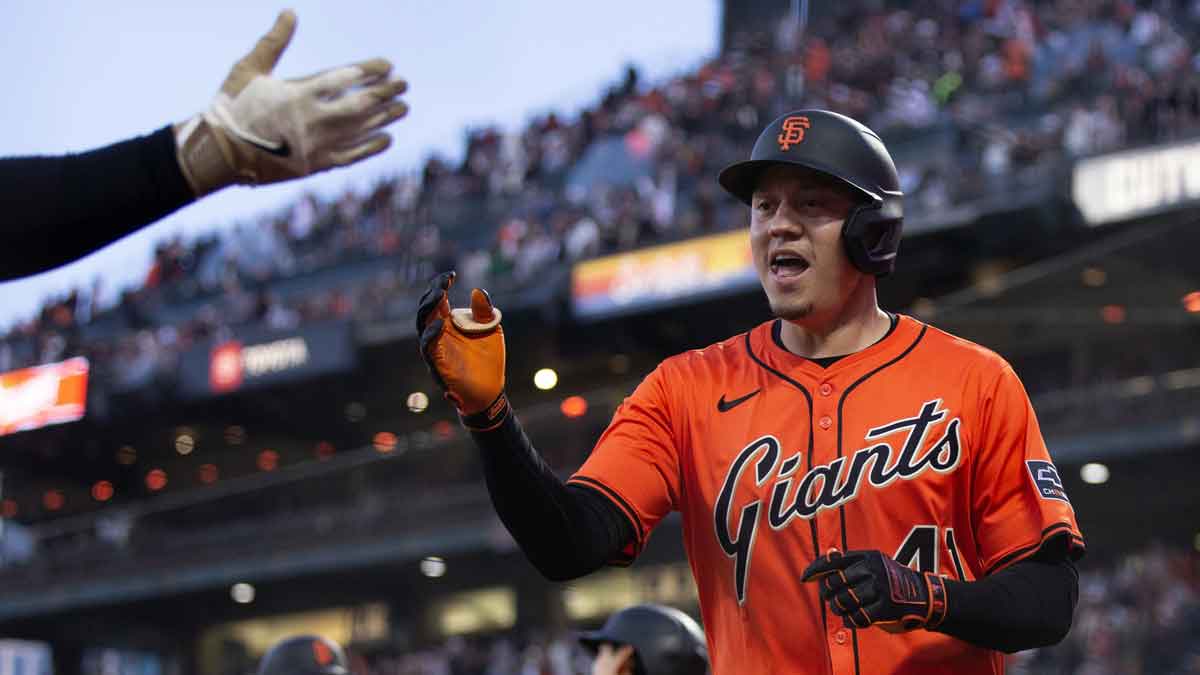 San Francisco Giants first baseman Wilmer Flores (41) is greeted by his teammates after hitting a grand slam against the Athletics during the third inning at Oracle Park.