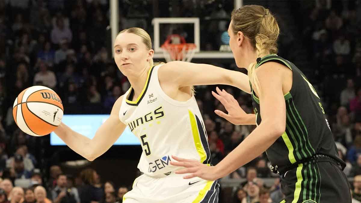 Dallas Wings guard Paige Bueckers passes against Minnesota Lynx forward Alanna Smith in the second quarter at Target Center.