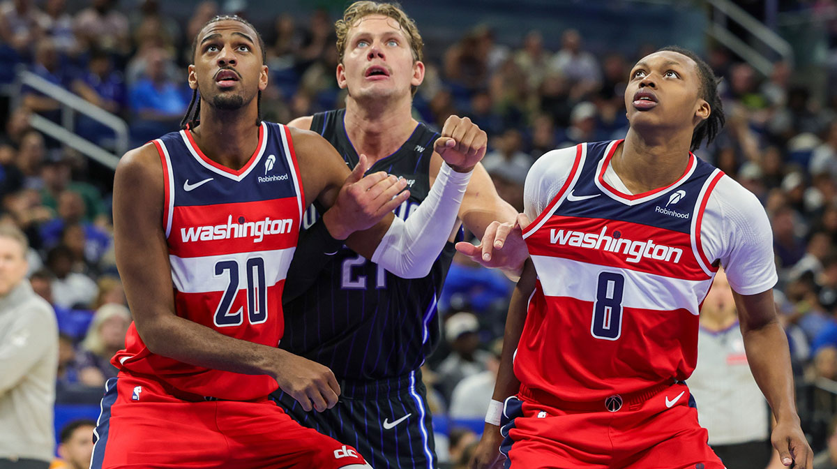 Washington Wizards forward Alexandre Sarr (20), guard Carlton Carrington (8) and Orlando Magic center Moritz Wagner (21) watch for the rebound during the second half at Kia Center.