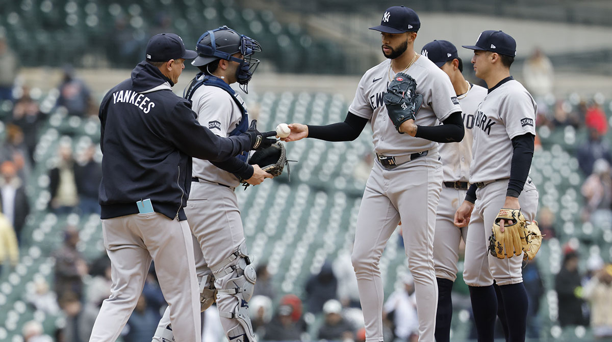 New York Yankees manager Aaron Boone (17) takes the ball to relieve pitcher Devin Williams (38) in the ninth inning against the Detroit Tigers at Comerica Park.
