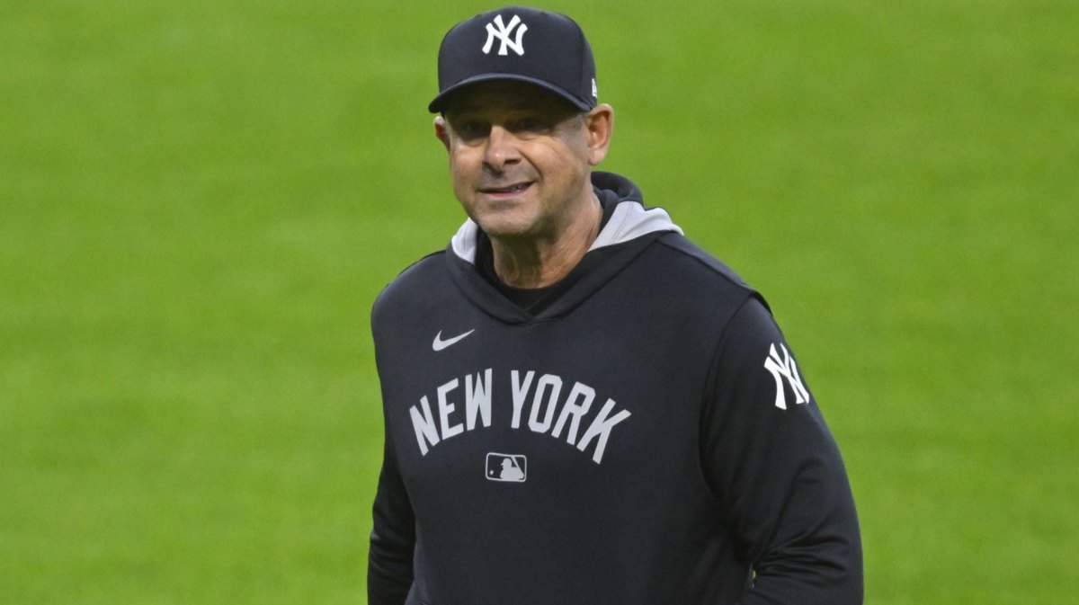 New York Yankees manager Aaron Boone (17) walks on the field during a pitching change in the sixth inning against the Cleveland Guardians at Progressive Field