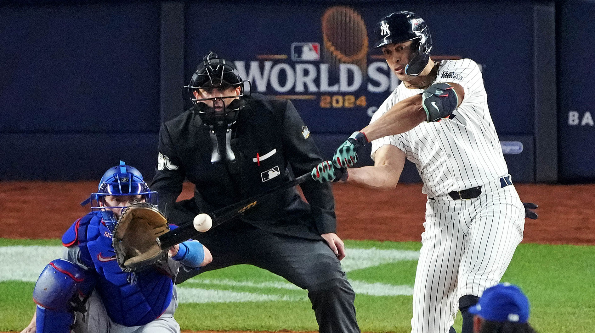 New York Yankees designated hitter Giancarlo Stanton (27) hits an RBI sacrifice fly during the sixth inning against the Los Angeles Dodgers in game four of the 2024 MLB World Series at Yankee Stadium.