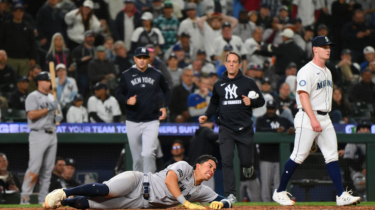 New York Yankees third baseman Oswaldo Cabrera (95) in pain after scoring a run against the Seattle Mariners during the eighth inning at T-Mobile Park.