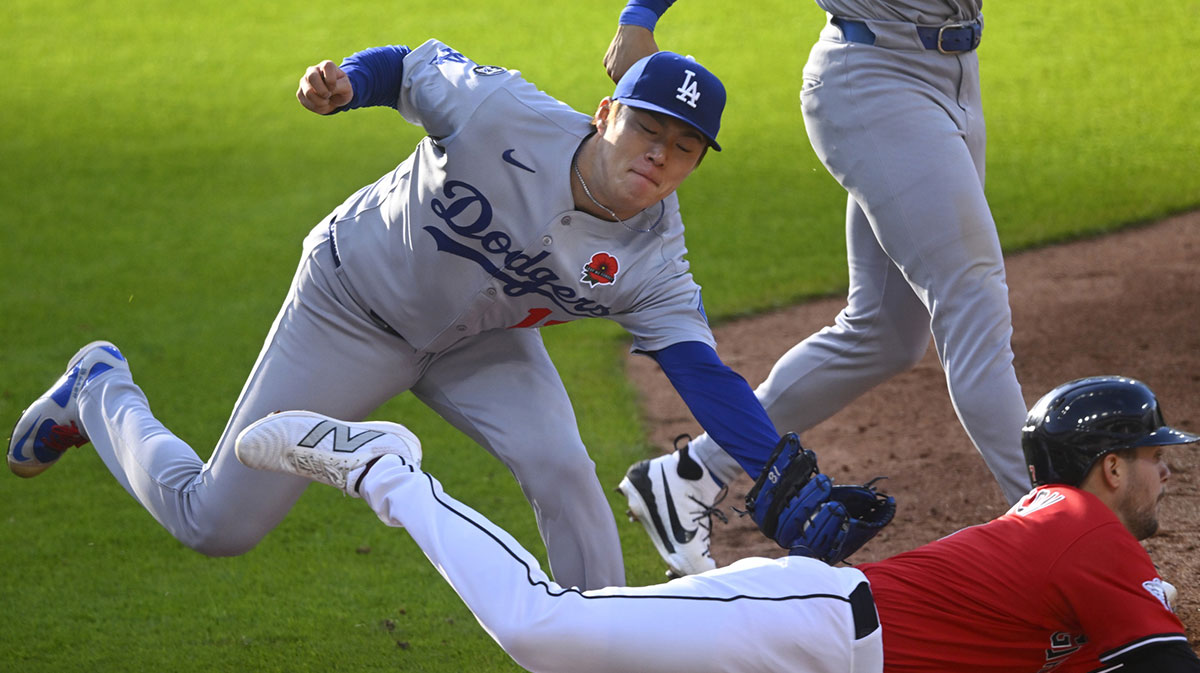 Los Angeles Dodgers starting pitcher Yoshinobu Yamamoto (18) tags out Cleveland Guardians second baseman Will Wilson (7) in the third inning at Progressive Field.