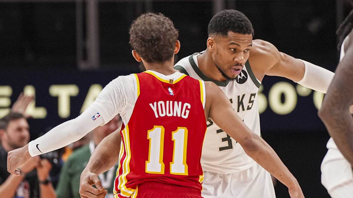 Milwaukee Bucks forward Giannis Antetokounmpo (34) reacts with Atlanta Hawks guard Trae Young (11) after the Bucks defeated the Hawks at State Farm Arena.