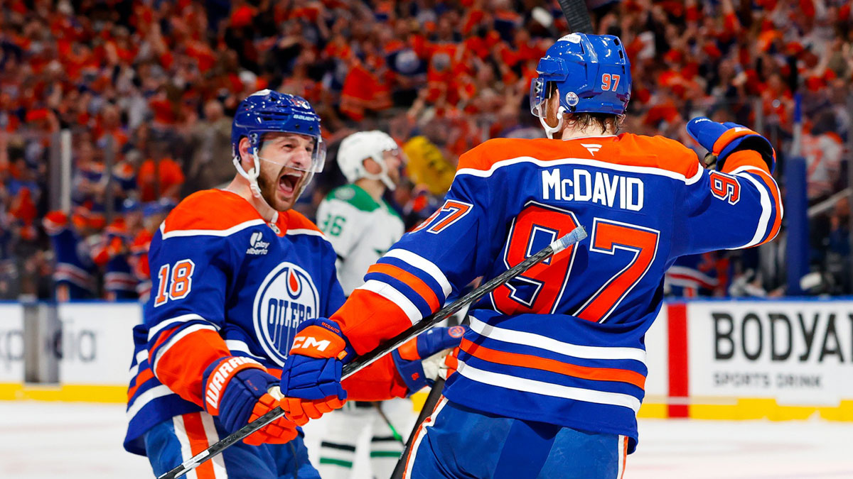 Edmonton Oilers left wing Zach Hyman (18) and center Connor McDavid (97) celebrates a goal scored by McDavid against the Dallas Stars during the first period in game three of the Western Conference Final of the 2025 Stanley Cup Playoffs at Rogers Place.