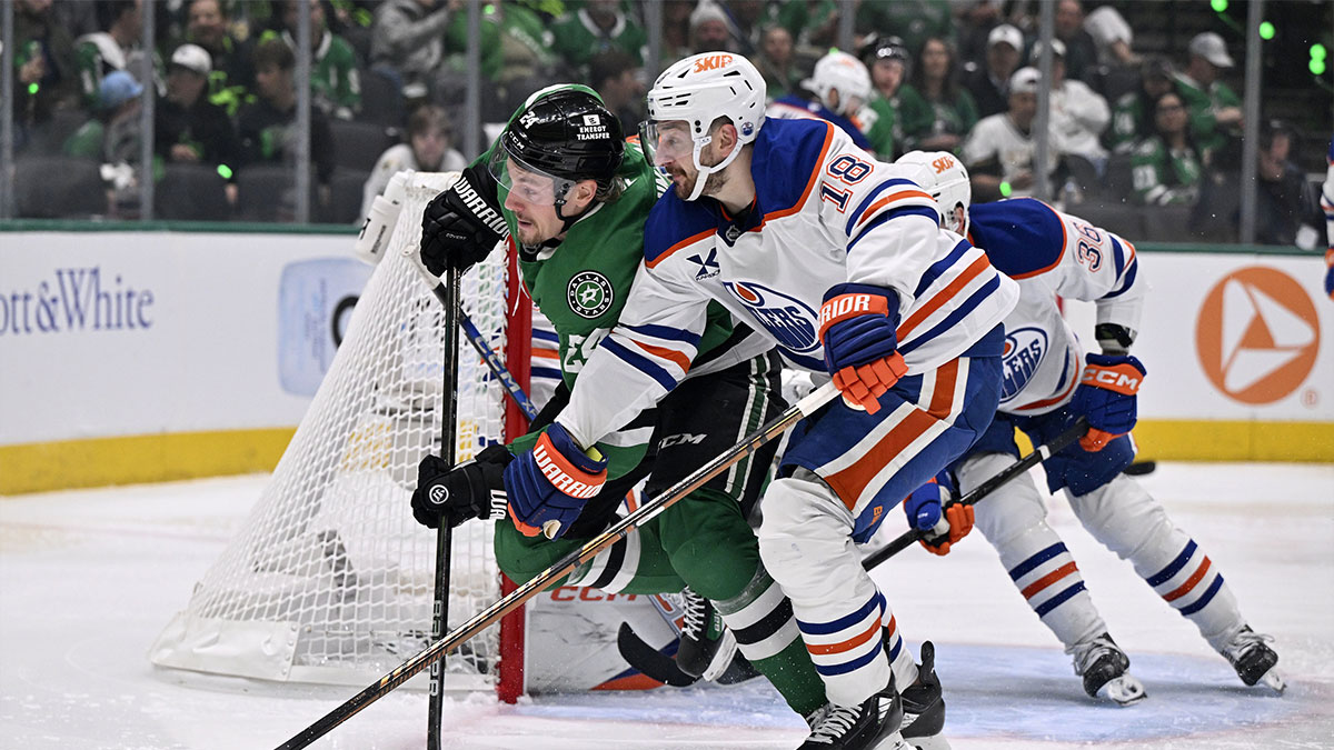 Dallas Stars center Roope Hintz (24) and Edmonton Oilers left wing Zach Hyman (18) skate for a puck in the second period during game one of the Western Conference Final of the 2025 Stanley Cup Playoffs at American Airlines Center.
