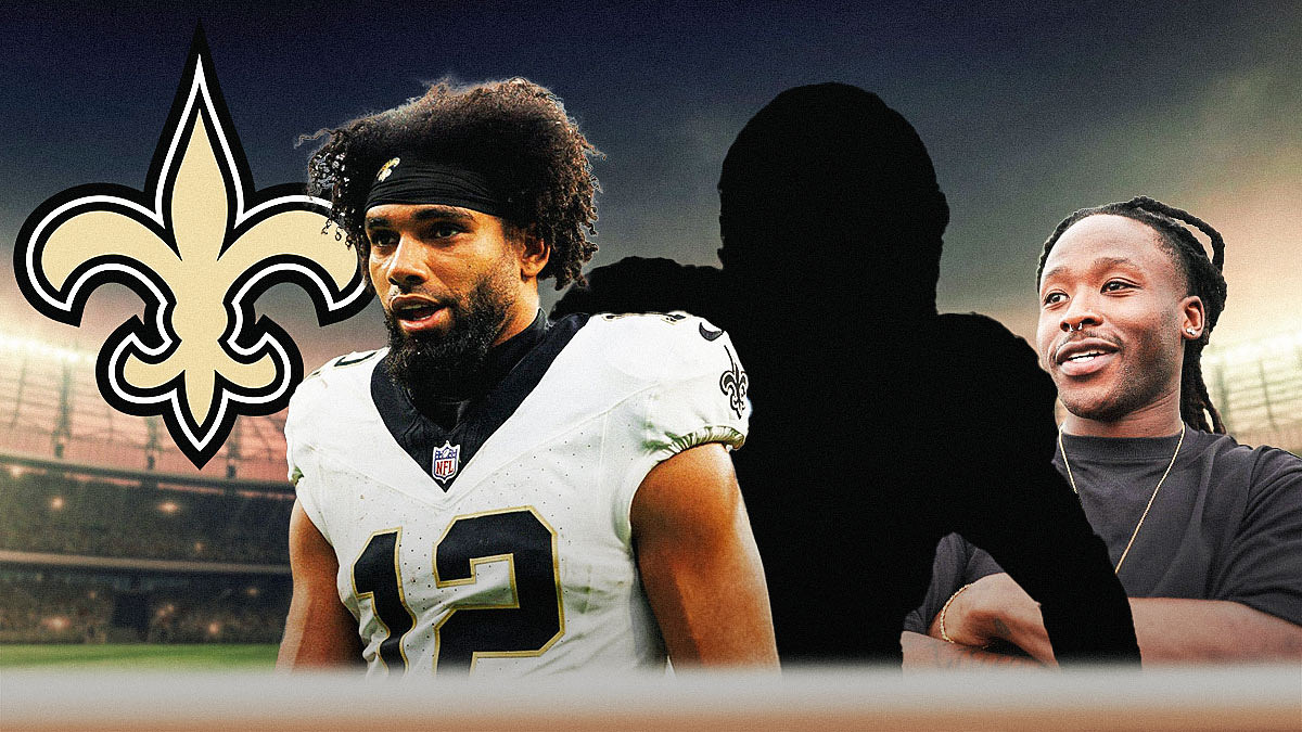 Mystery player in the middle, Chris Olave and Alvin Kamara around him, Saints logo in the background