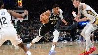 Milwaukee Bucks forward Giannis Antetokounmpo (34) drives for the basket against New Orleans Pelicans center Kylor Kelley (35) in the third quarter at Fiserv Forum.