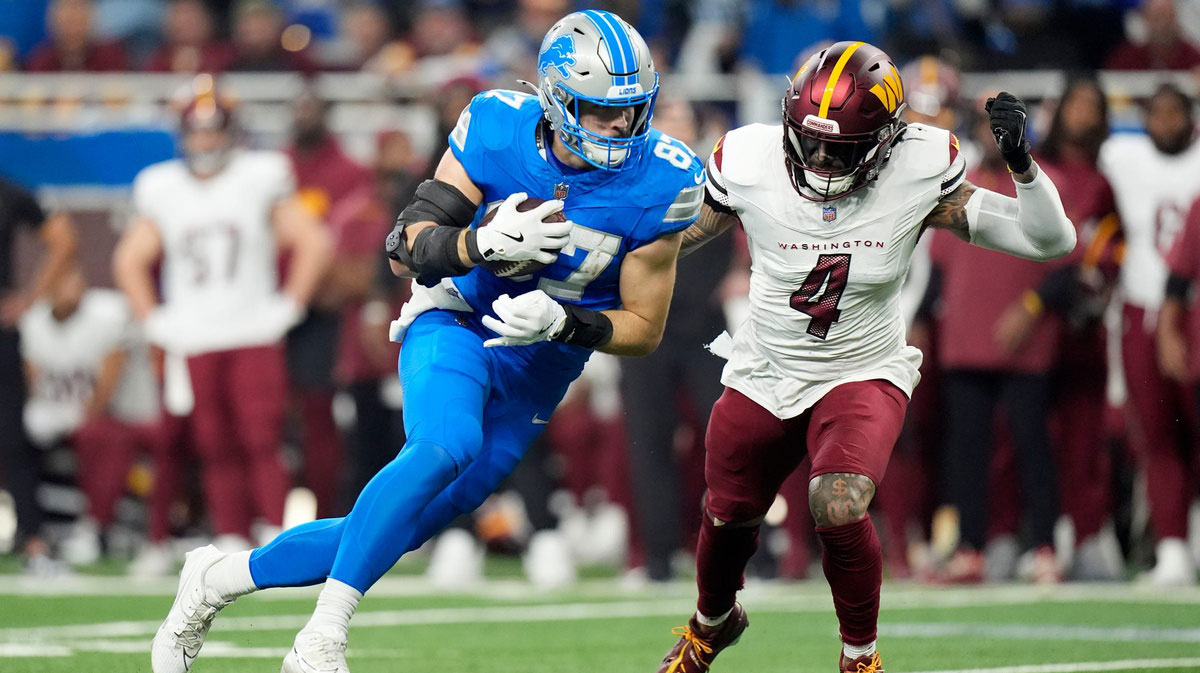 Detroit Lions tight end Sam LaPorta (87) looks for yards against Washington Commanders linebacker Frankie Luvu (4) in the first quarter against in the NFC divisional round at Ford Field in Detroit on Saturday, Jan. 18, 2025.