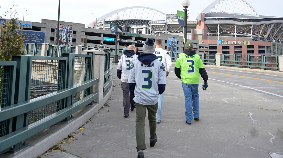 General overall view of the CenturyLink Field exterior and the downtown Seattle skyline as Seattle Seahawks fans wearing No. 3 jerseys of quarterback Russell Wilson (3) arrive to the NFL game against the Green Bay Packers.