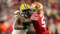 Linebacker Dre Greenlaw (57) tackles Green Bay Packers running back Emanuel Wilson (31) during the first quarter in a 2024 NFC divisional round game