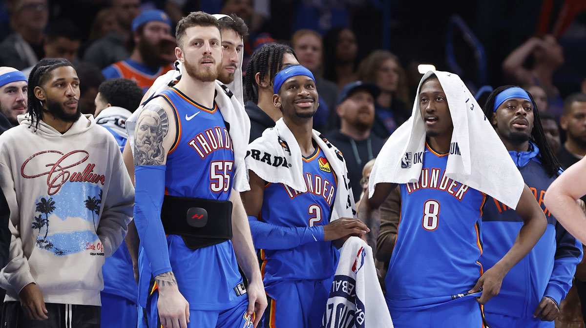 Oklahoma City Thunder guard Isaiah Joe (11), center Isaiah Hartenstein (55), forward Chet Holmgren (7), guard Shai Gilgeous-Alexander (2), forward Jalen Williams (8) and guard Luguentz Dort (5) watch the end of a game against the New Orleans Pelicans at Paycom Center.