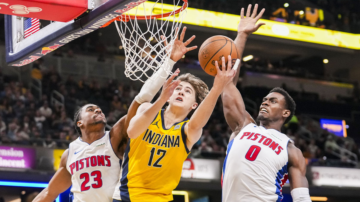 Indiana Pacers forward Johnny Furphy (12) goes up for a shot against Detroit Pistons guard Jaden Ivey (23) and Detroit Pistons center Jalen Duren (0) on Friday, Nov. 29, 2024, during a game between the Indiana Pacers and the Detroit Pistons at Gainbridge Fieldhouse in Indianapolis.