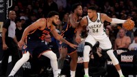 Milwaukee Bucks forward Giannis Antetokounmpo (34) controls the ball against New York Knicks forward OG Anunoby (8) and center Karl-Anthony Towns (32) during the third quarter at Madison Square Garden.