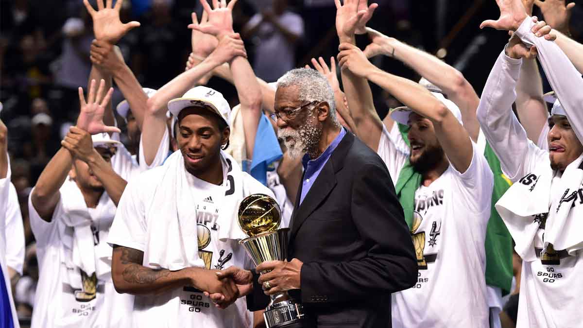 NBA former player Bill Russel gives San Antonio Spurs forward Kawhi Leonard (2) the NBA Finals MVP trophy after game five of the 2014 NBA Finals against the Miami Heat at AT&T Center. The Spurs beat the Heat 104-87 to win the NBA Finals.