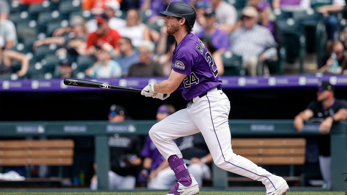 Colorado Rockies third baseman Ryan McMahon (24) hits a single in the sixth inning against the New York Mets at Coors Field.