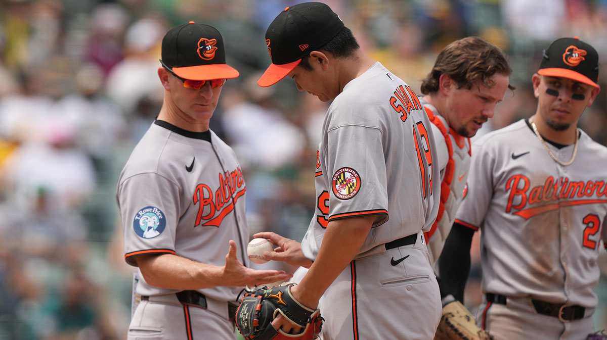 Baltimore Orioles starting pitcher Tomoyuki Sugano (center right) hands the game ball to interim manager Tony Mansolino (left) during the fifth inning against the Athletics at Sutter Health Park. MLB trade deadline