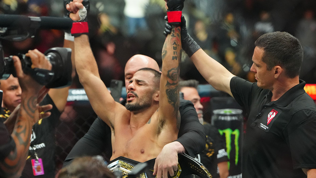 Alexandre Pantoja (red gloves) reacts after defeating Kai Asakura (blues gloves) at T-Mobile Arena.