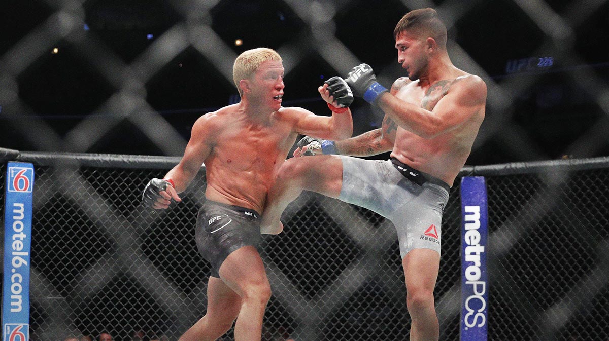 Sergio Pettis (blue gloves) fights Joseph Benavidez (red gloves) during UFC 225 at United Center.
