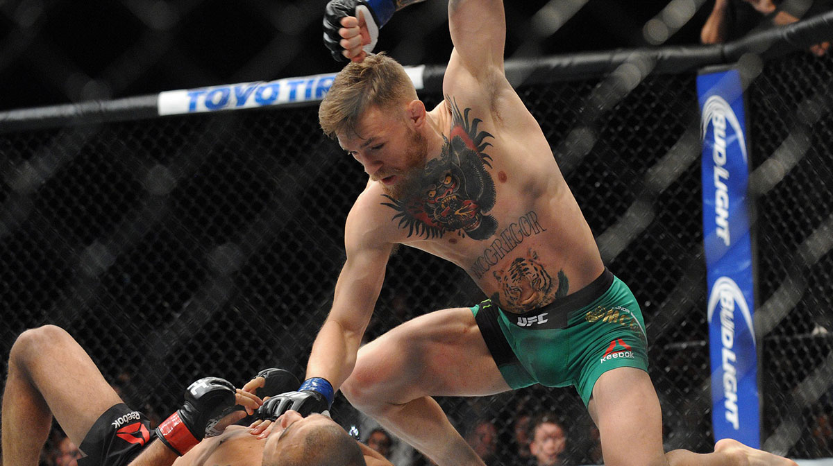 Conor McGregor lands punches to win via technical knockout against Jose Aldo during UFC 194 at MGM Grand Garden Arena.
