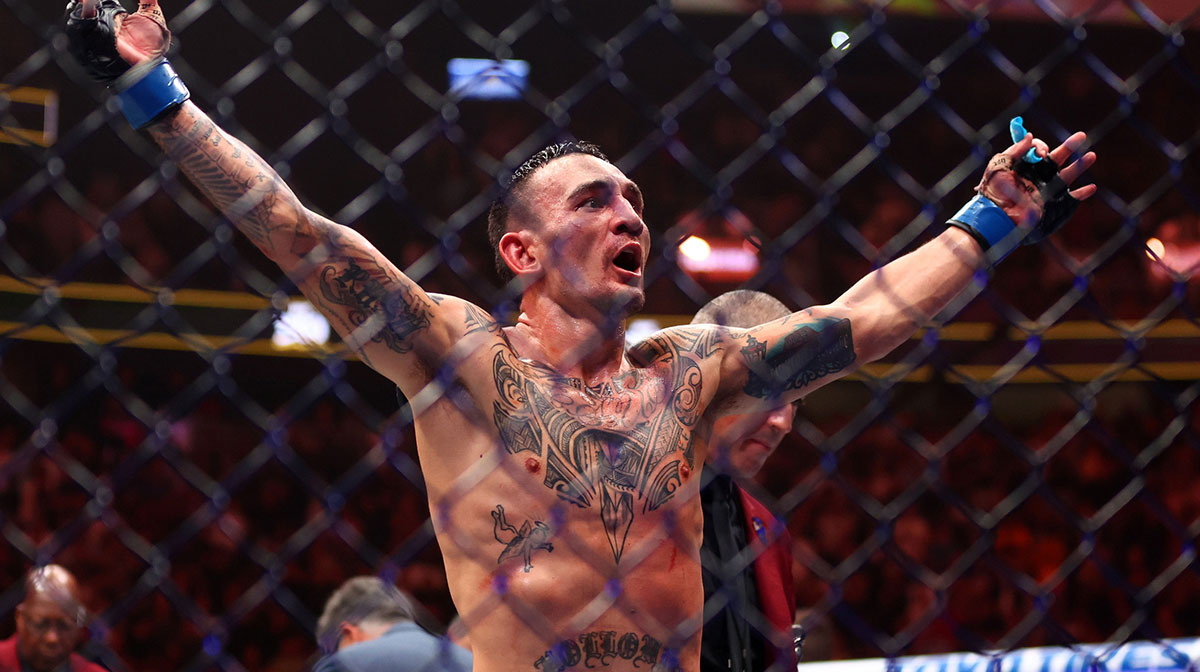 Max Holloway (blue gloves) reacts after defeating Justin Gaethje (not pictured) during UFC 300 at T-Mobile Arena.