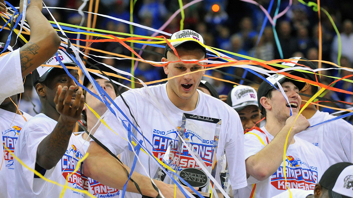 Members of the Kansas Jayhawks including center Cole Aldrich (center) hold the championship trophy after the finals of the mens Big 12 Tournament against the Kansas State Wildcats at the Sprint Center. The Jayhawks defeated the Wildcats 72-64.