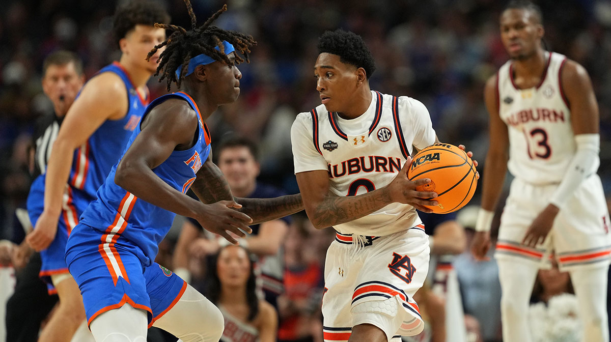 Auburn Tigers guard Tahaad Pettiford (0) controls the ball against Florida Gatorsguard Denzel Aberdeen (11) during the second half in the semifinals of the men's Final Four of the 2025 NCAA Tournament at the Alamodome.