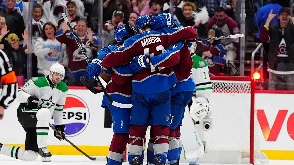 Colorado Avalanche defenseman Samuel Girard (49) (left) celebrates his goal scored with teammates in the third period against the Dallas Stars at Ball Arena.