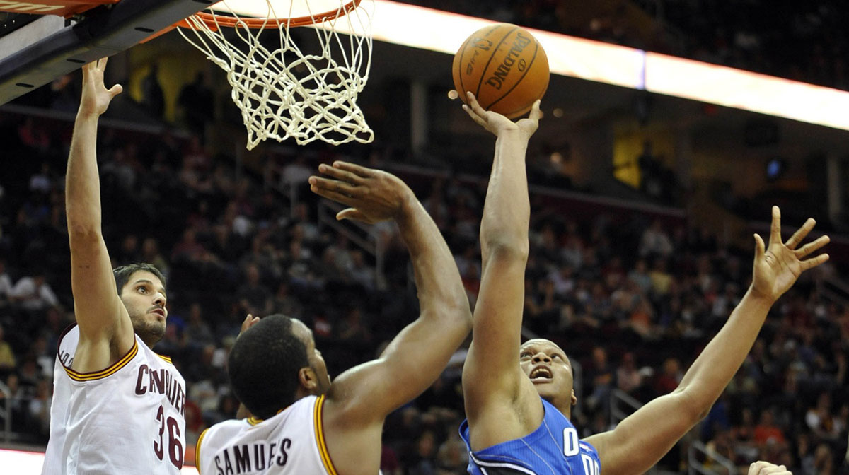 Orlando Magic power forward Daniel Orton (right) shoots against Cleveland Cavaliers small forward Omri Casspi (36) and power forward Samardo Samuels (24) in the fourth quarter at Quicken Loans Arena.