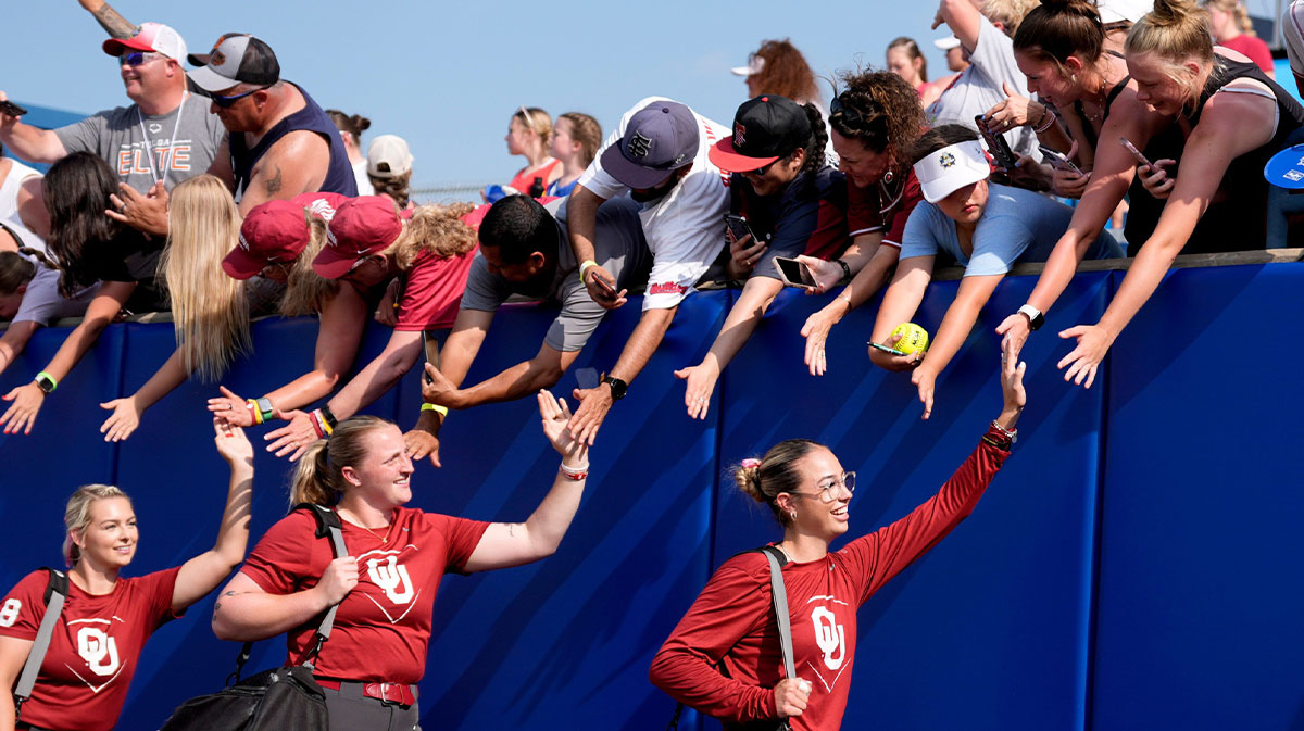 Oklahoma's Sam Landry greets fans before the Women's College World Series softball game between the Texas Tech Raiders and the Oklahoma Sooners at Devon Park.