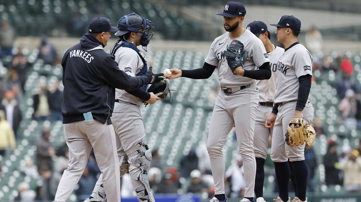 New York Yankees manager Aaron Boone (17) takes the ball to relieve pitcher Devin Williams (38) in the ninth inning against the Detroit Tigers.
