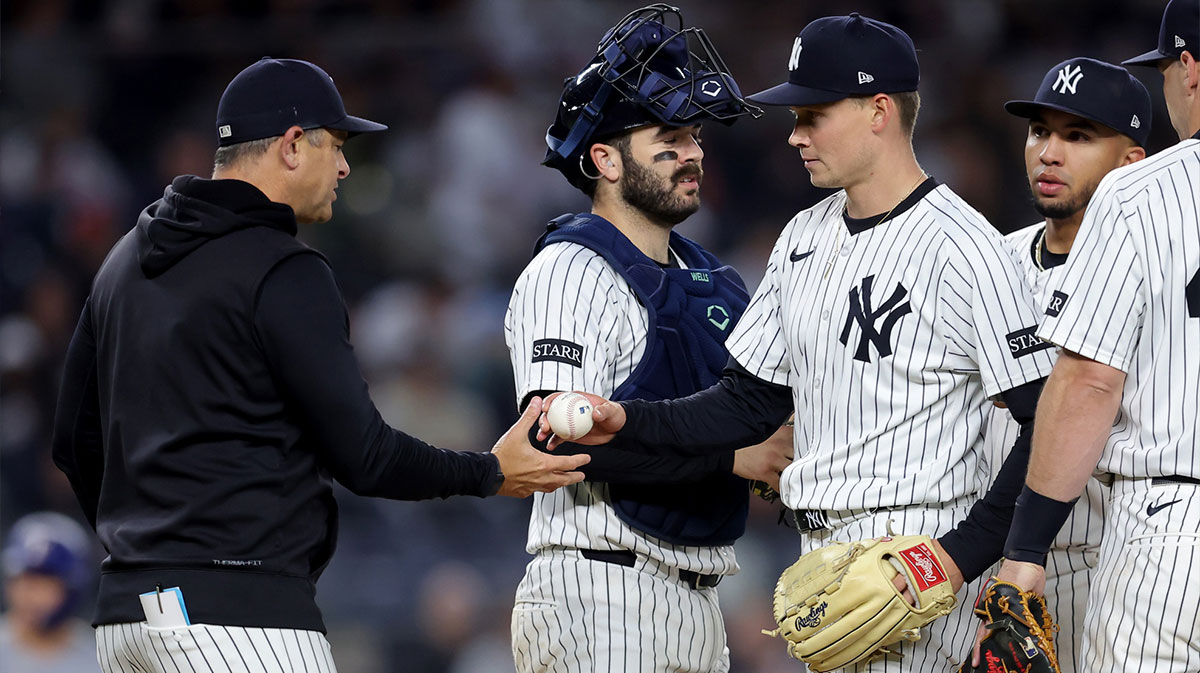 New York Yankees manager Aaron Boone (17) takes the ball from New York Yankees starting pitcher Will Warren (98) during a pitching change during the sixth inning against the Texas Rangers at Yankee Stadium.