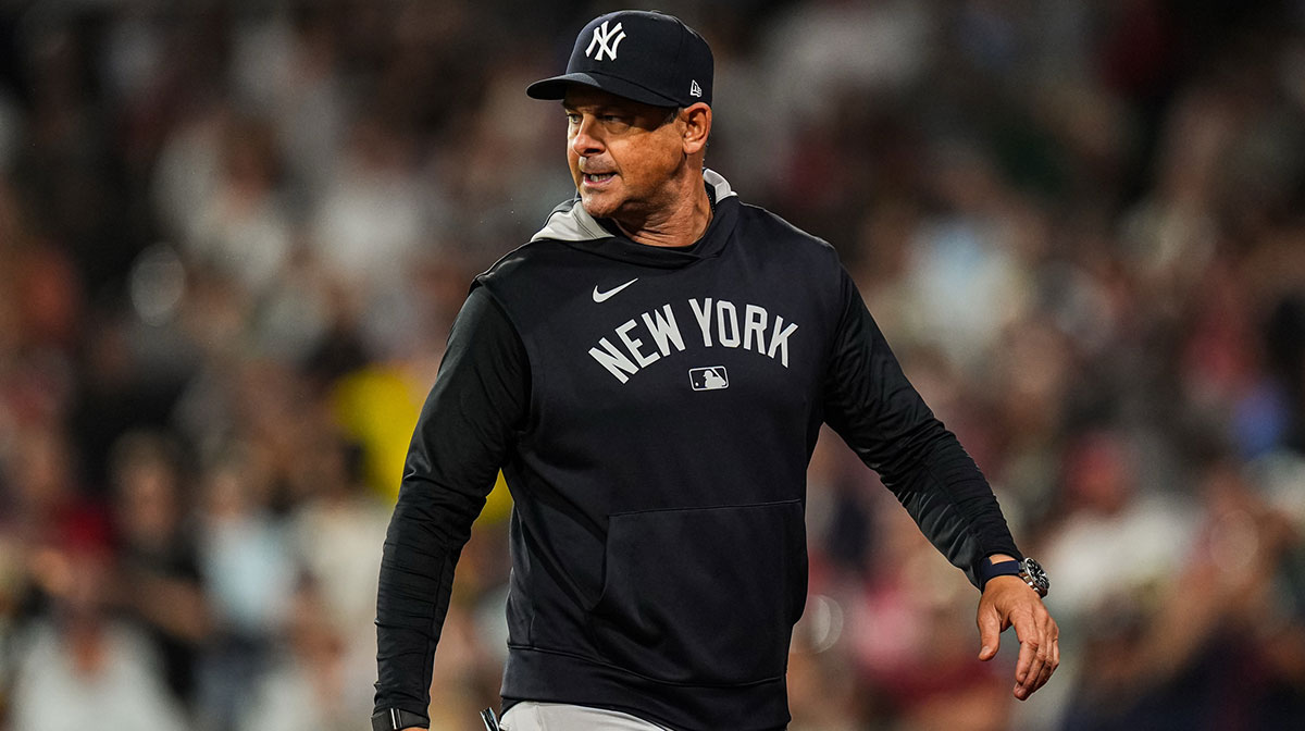 New York Yankees manager Aaron Boone (17) has words with the officials as they take on the Boston Red Sox in the tenth inning at Fenway Park.