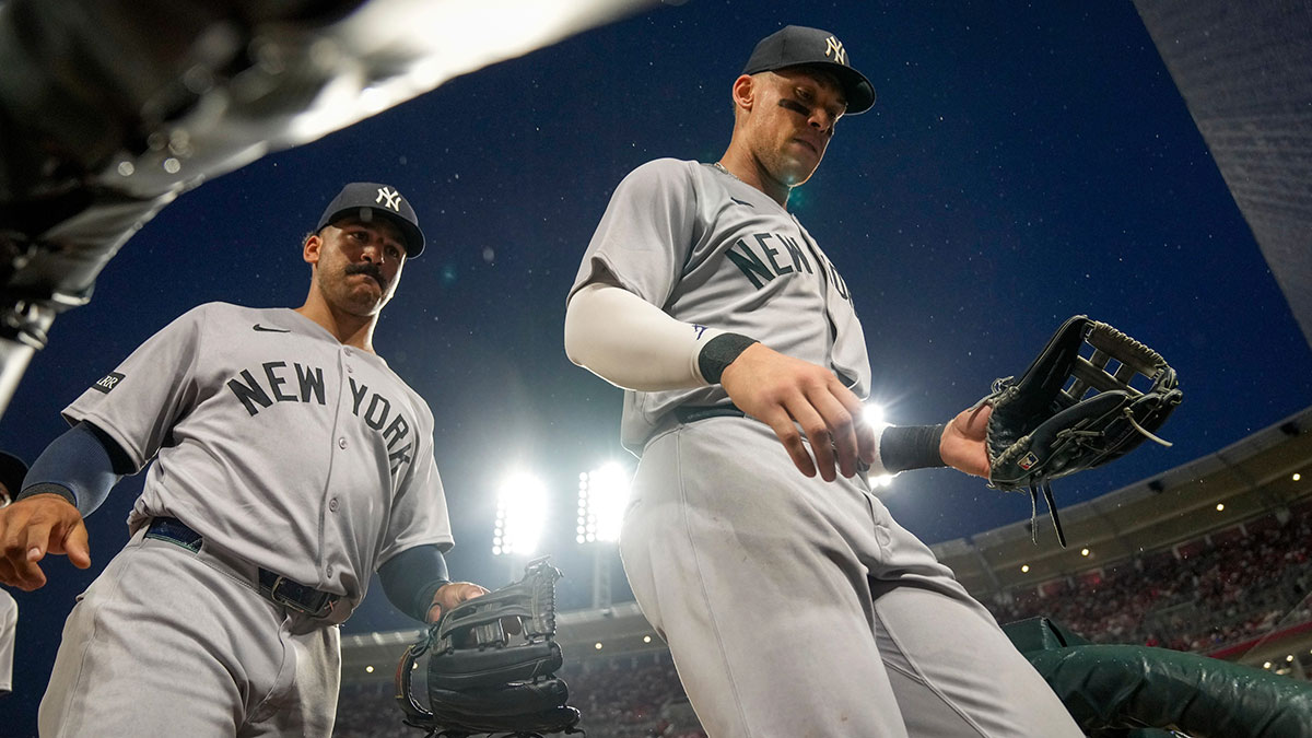New York Yankees right fielder Aaron Judge (99) and center fielder Trent Grisham (12) return to the dugout after the eighth inning of the MLB interleague game between the Cincinnati Reds and the New York Yankees at Great American Ball Park.